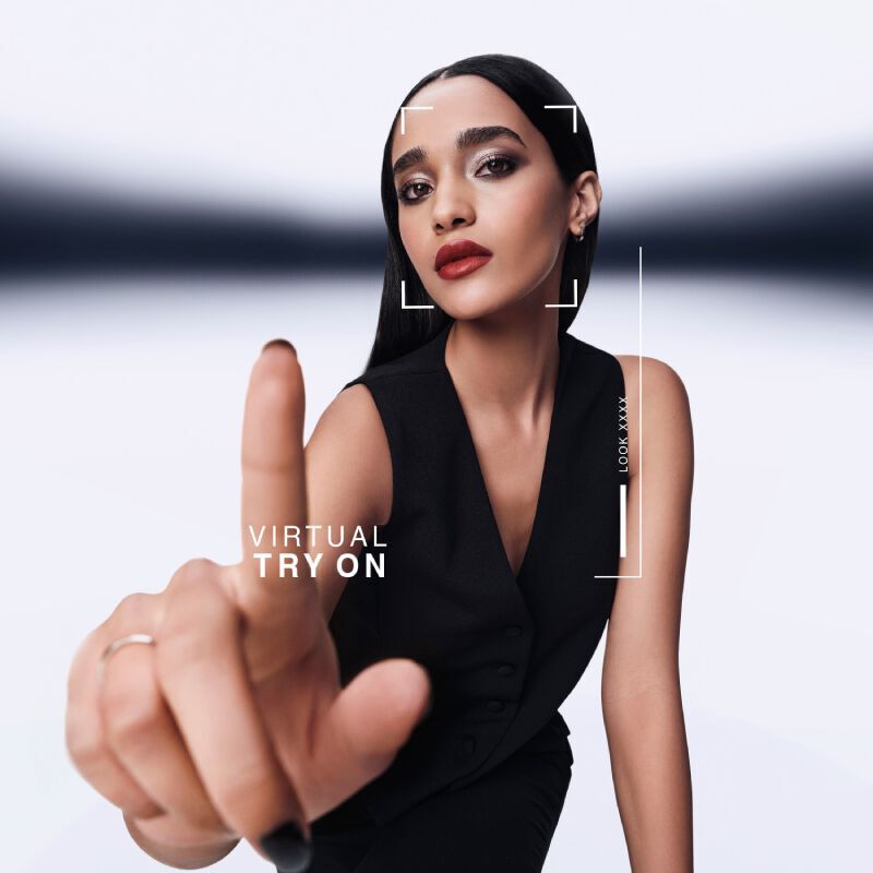Model with sleek black hair and nails engaging with YSL's Virtual Try- On interface, modern and interactive.