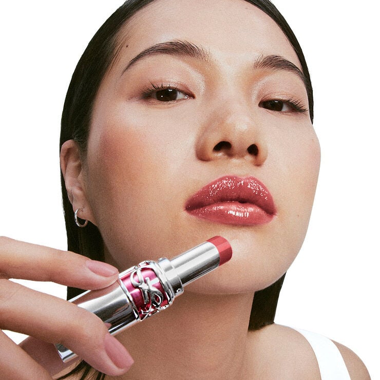 Model Jiangyue applies YSL LOVESHINE Candy Glaze in Watermelon High, shade 16, to glossy lips, vibrant, luminous finish.