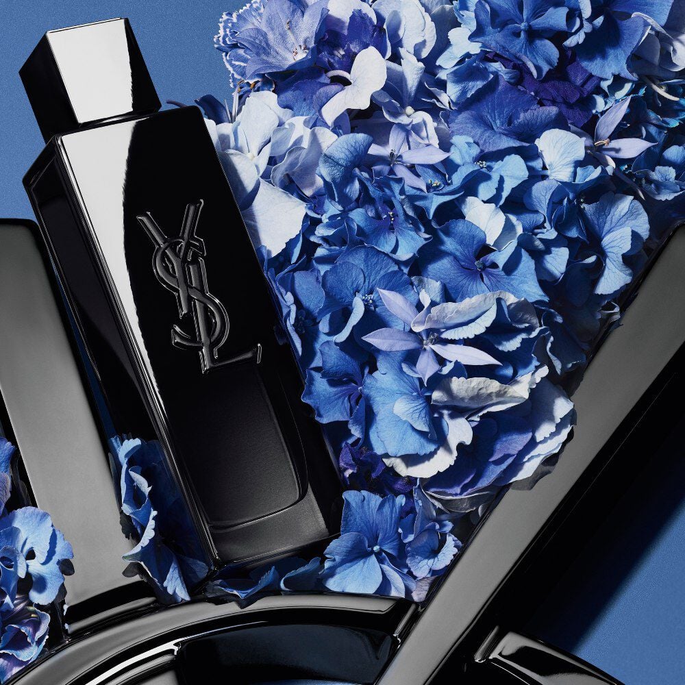 Pierre-Antoine, a male model, elegantly holds
a sleek black YSL Beauty gift box featuring the
iconic Cassandre logo.