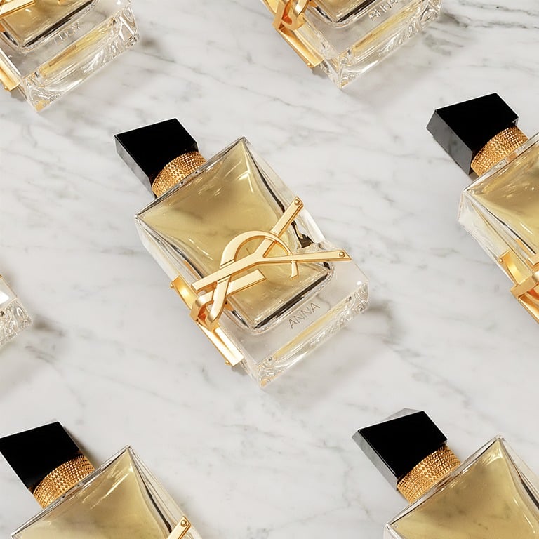 Pierre-Antoine, a male model, elegantly holds
a sleek black YSL Beauty gift box featuring the
iconic Cassandre logo.