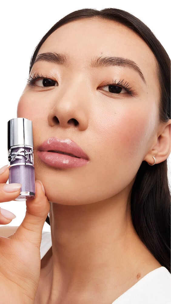 Song, light-skinned, with YSL LOVESHINE Plumping Gloss in Shade 1 Thunder Stealer, showcasing glossy lips.