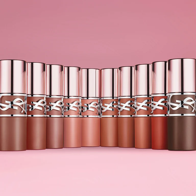 YSL LOVENUDE LIP STAIN collection
displaying ten nude shades in elegant
metallic packaging.