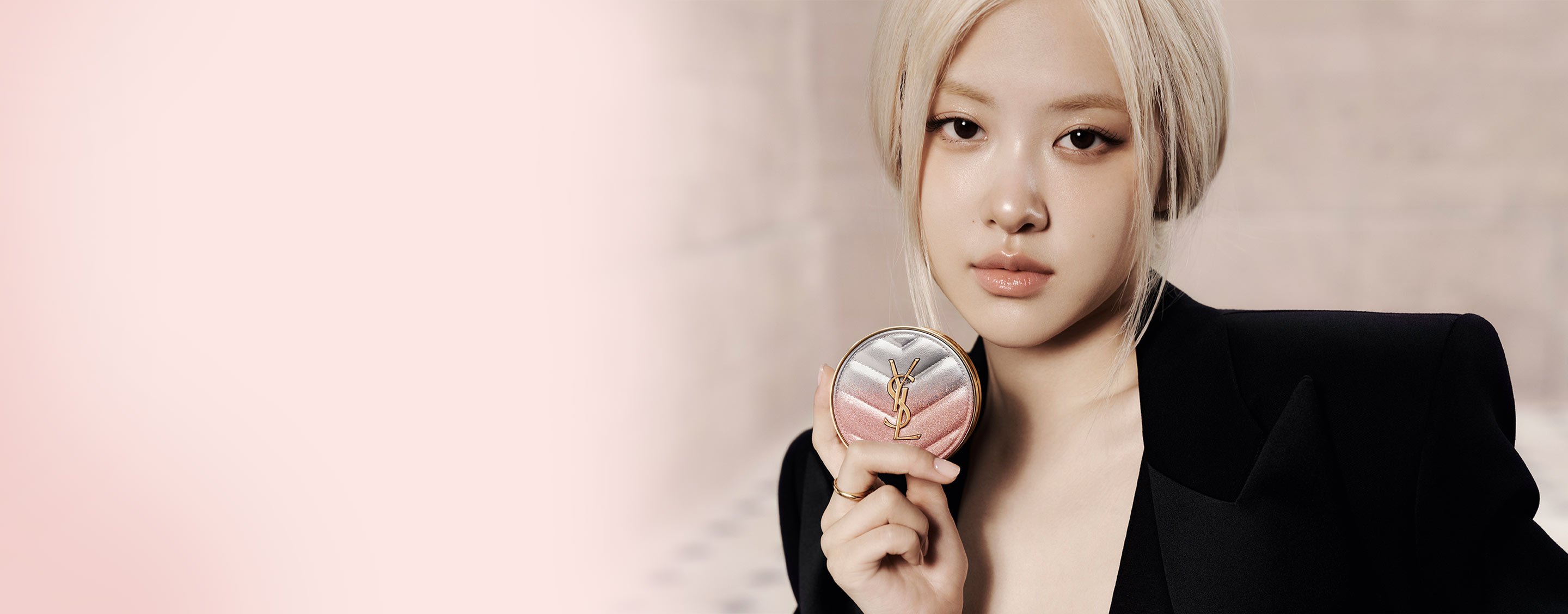 Model Loli Bahia holding YSL Rouge Pur Couture The Slim Lipstick in shade 835, applied on her lips, with a glitter case.